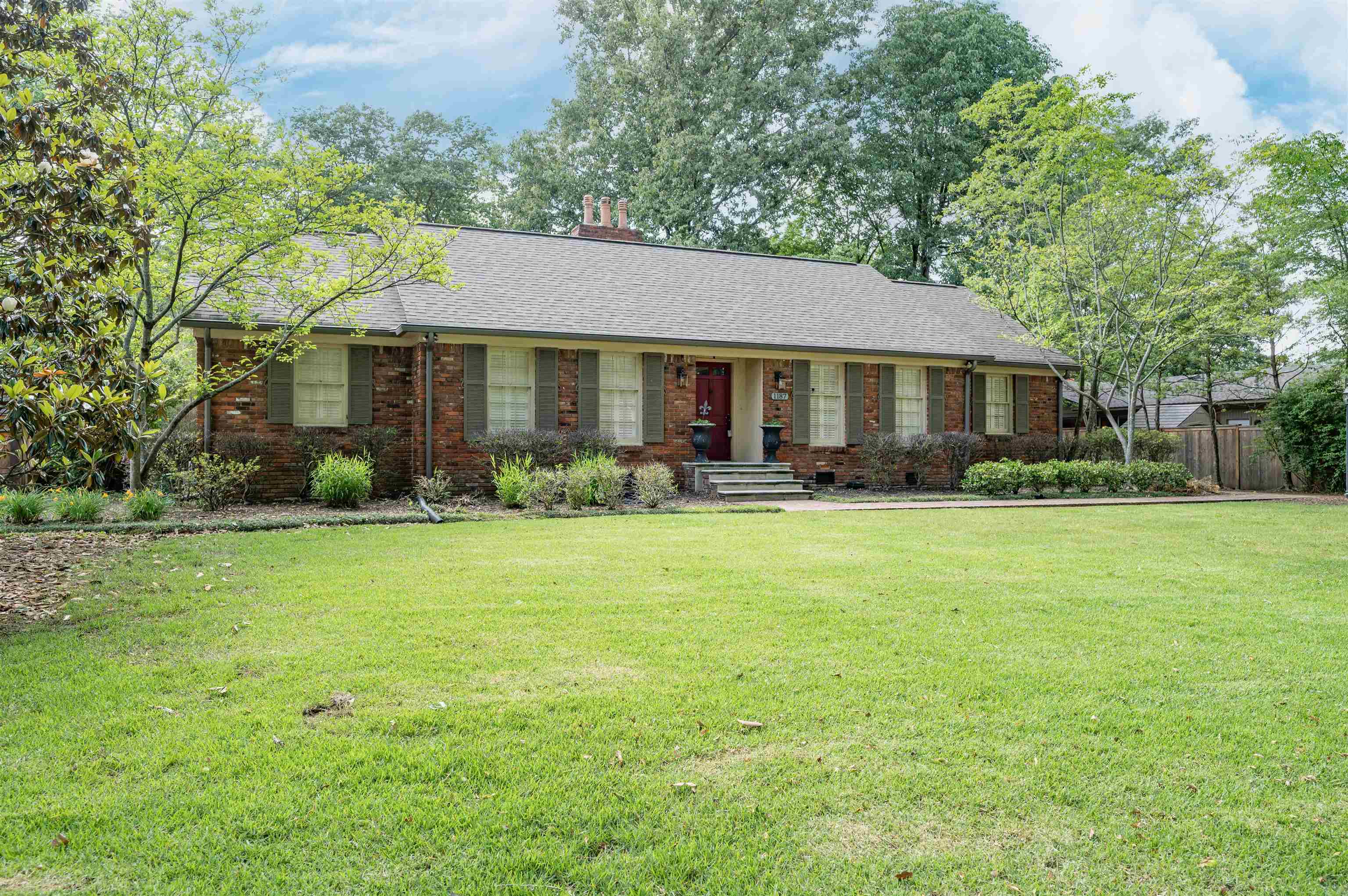 1187 Hayne Road Memphis, TN 38119 - Photo 1 of 25 a front view of a house with garden