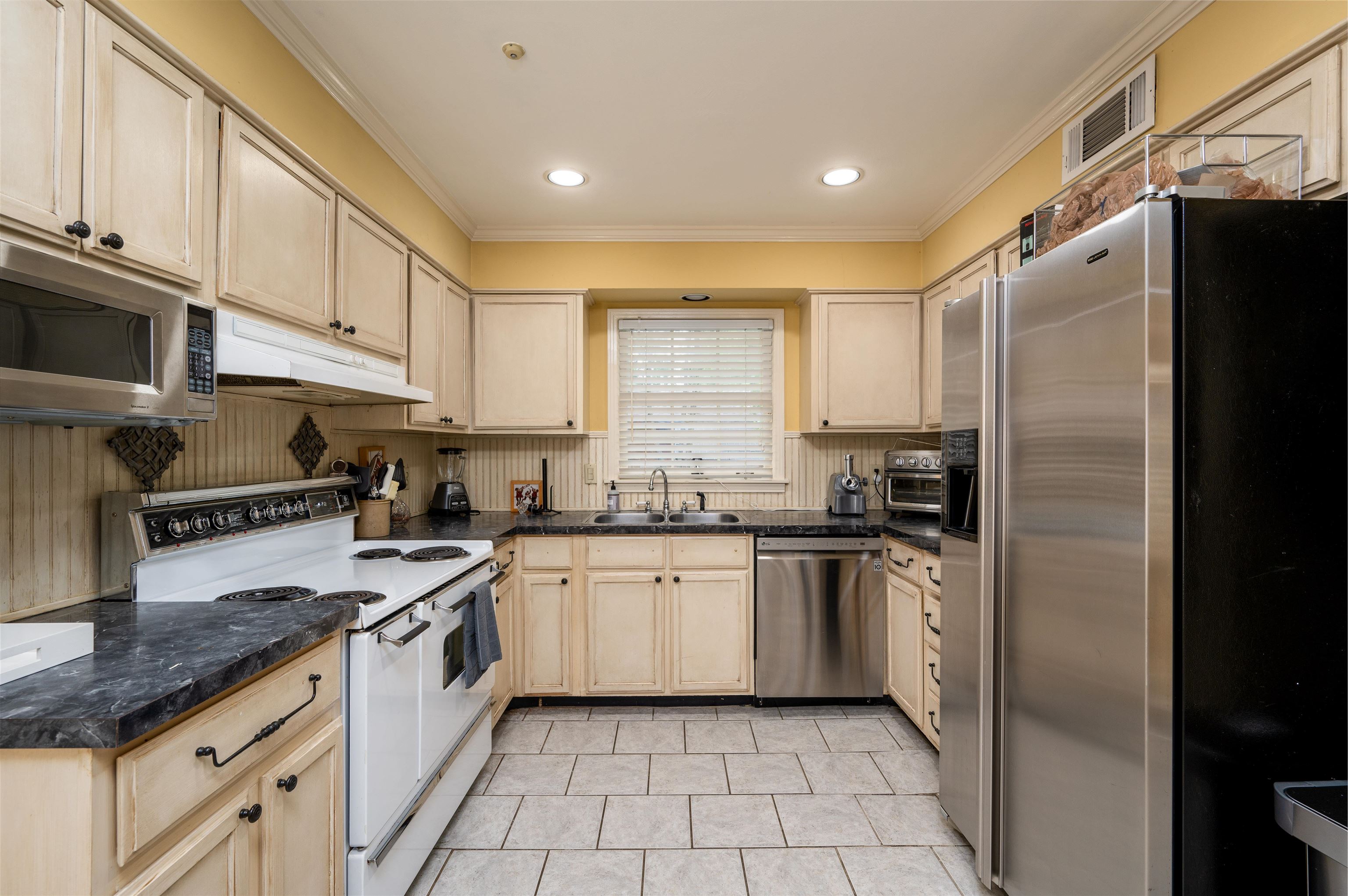 1187 Hayne Road Memphis, TN 38119 - Photo 11 of 25 a kitchen with stainless steel appliances granite countertop a stove a sink and a refrigerator