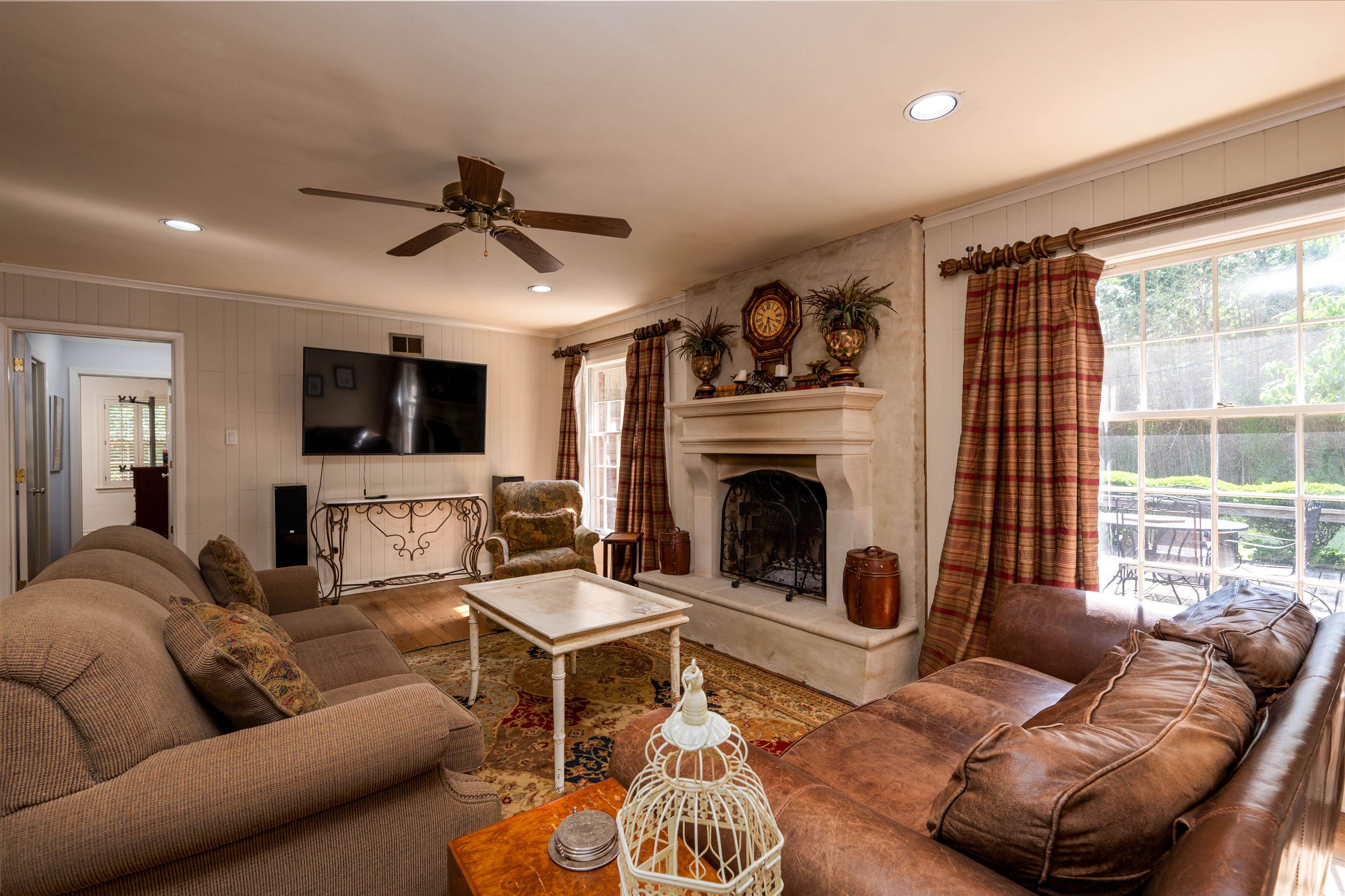 1187 Hayne Road Memphis, TN 38119 - Photo 13 of 25 a living room with furniture a flat screen tv and a fireplace