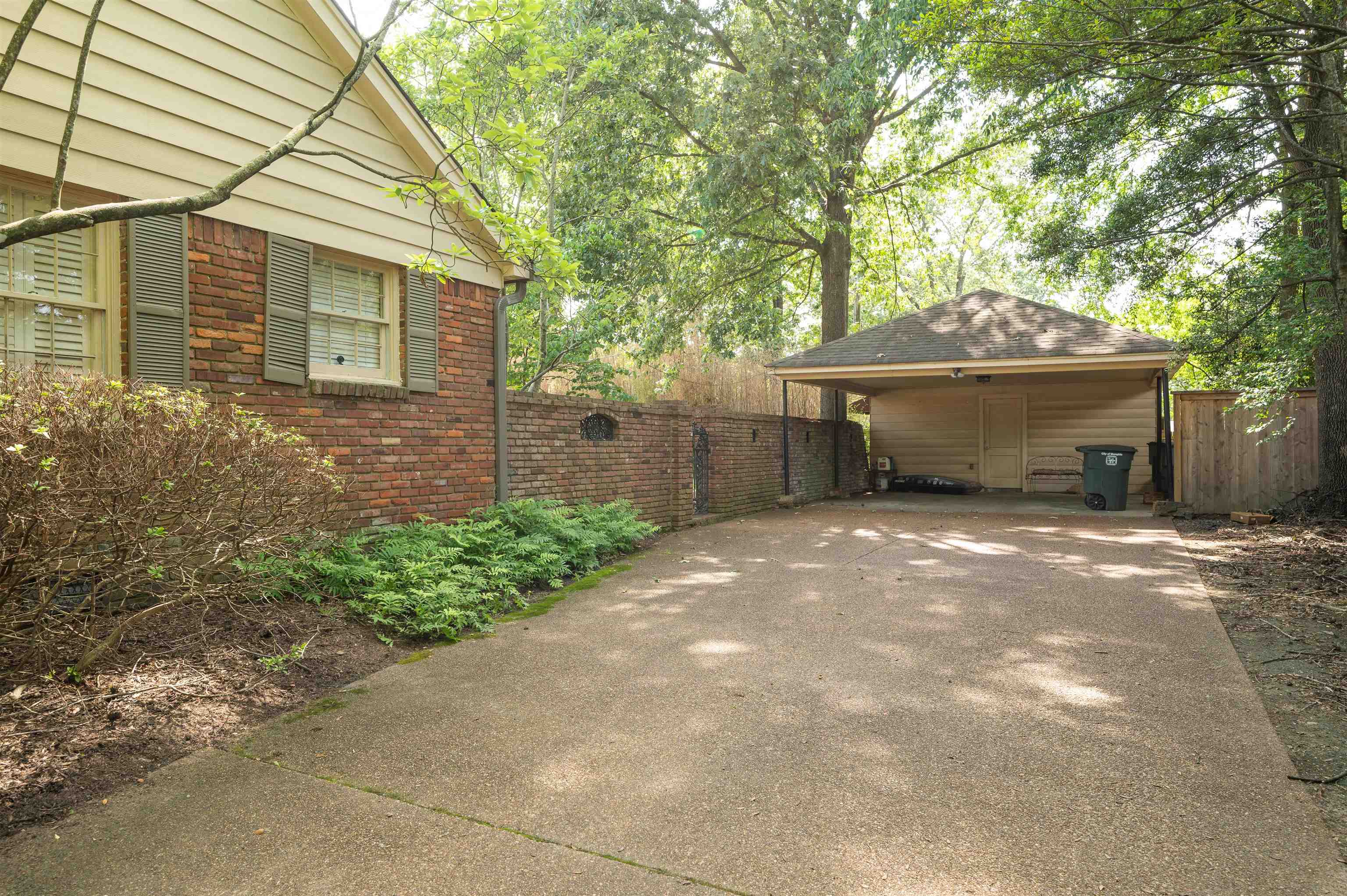 1187 Hayne Road Memphis, TN 38119 - Photo 5 of 25 a front view of a house with a garden