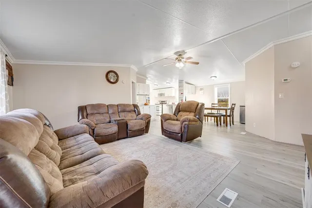 a living room with furniture kitchen view and a table