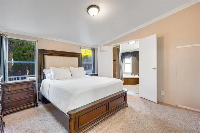 a bed room with a bed and a large window