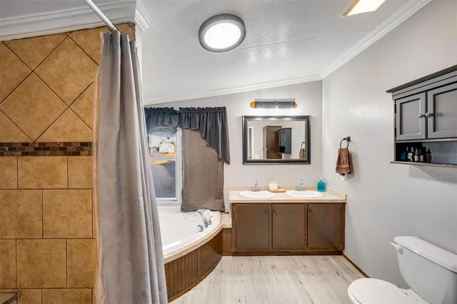a bathroom with a bathtub sink mirror and toilet
