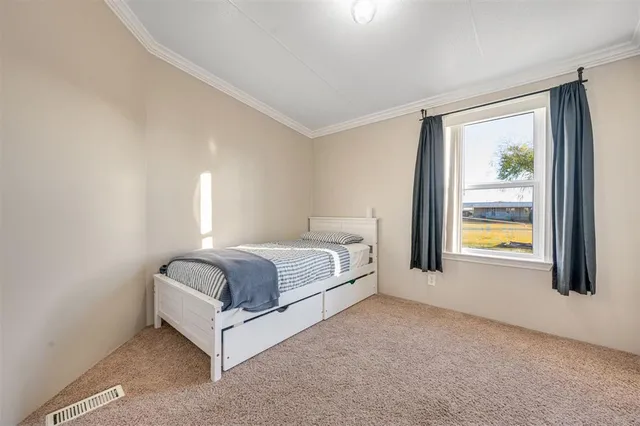 a spacious bedroom with a large bed and a window