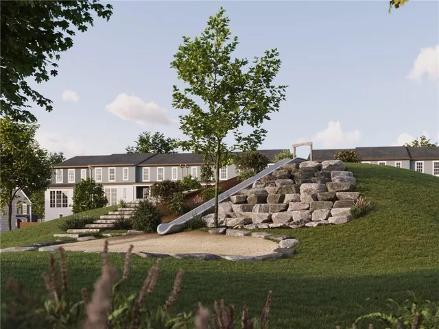 a front view of a house with a garden and yard