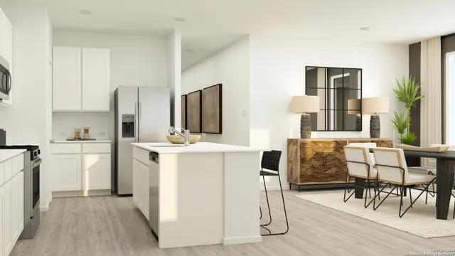 a kitchen with a refrigerator and table chairs