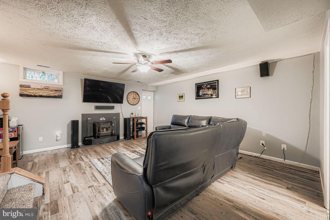 3329 Betterton Circle Abingdon, MD 21009 - Photo 23 of 38 a living room with furniture a fireplace and a flat screen tv