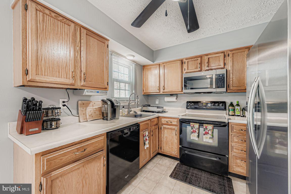 3329 Betterton Circle Abingdon, MD 21009 - Photo 8 of 38 a kitchen with stainless steel appliances granite countertop a stove a sink dishwasher and a microwave oven on the blue kitchen countertops