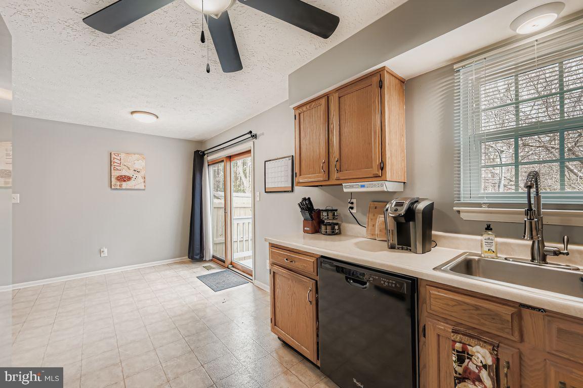 3329 Betterton Circle Abingdon, MD 21009 - Photo 10 of 38 a kitchen with stainless steel appliances granite countertop a sink window and cabinets