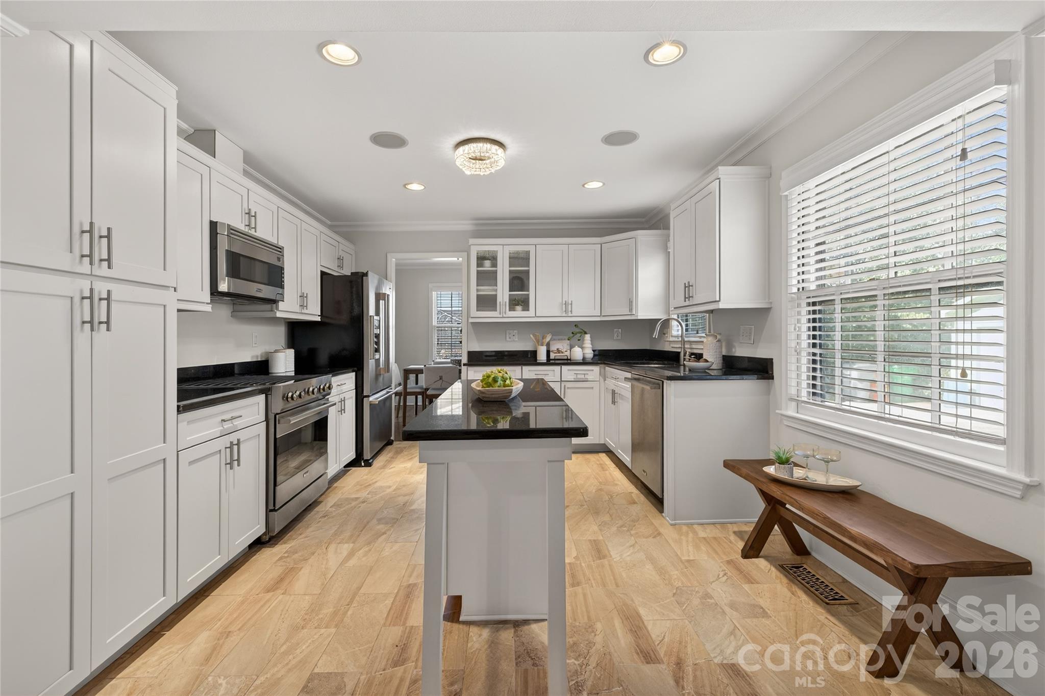 731 Sandridge Road Charlotte, NC 28210 - Photo 11 of 32 a kitchen with granite countertop a stove top oven a sink a dining table and chairs
