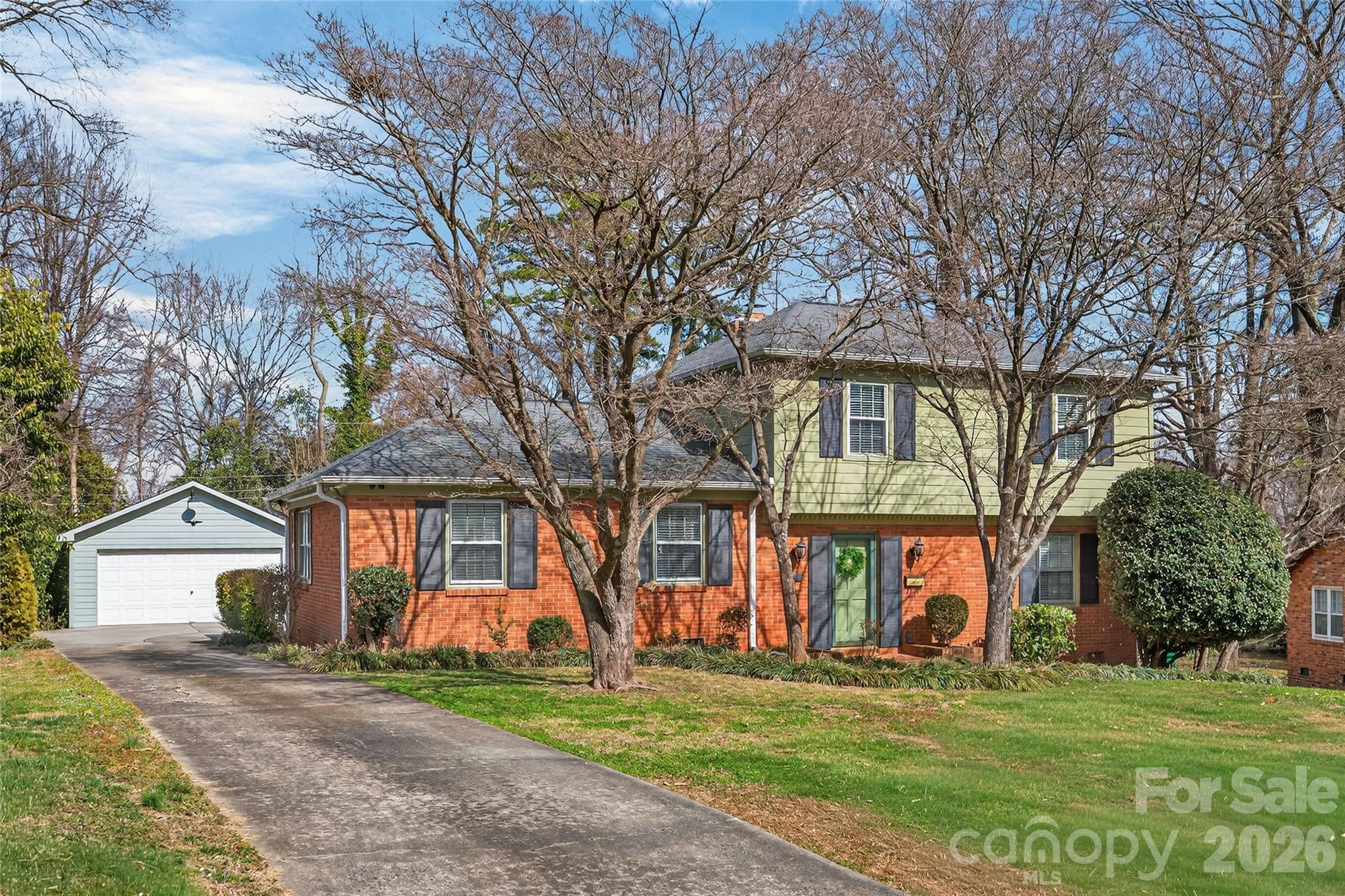 731 Sandridge Road Charlotte, NC 28210 - Photo 2 of 32 a view of a house with a yard and large trees