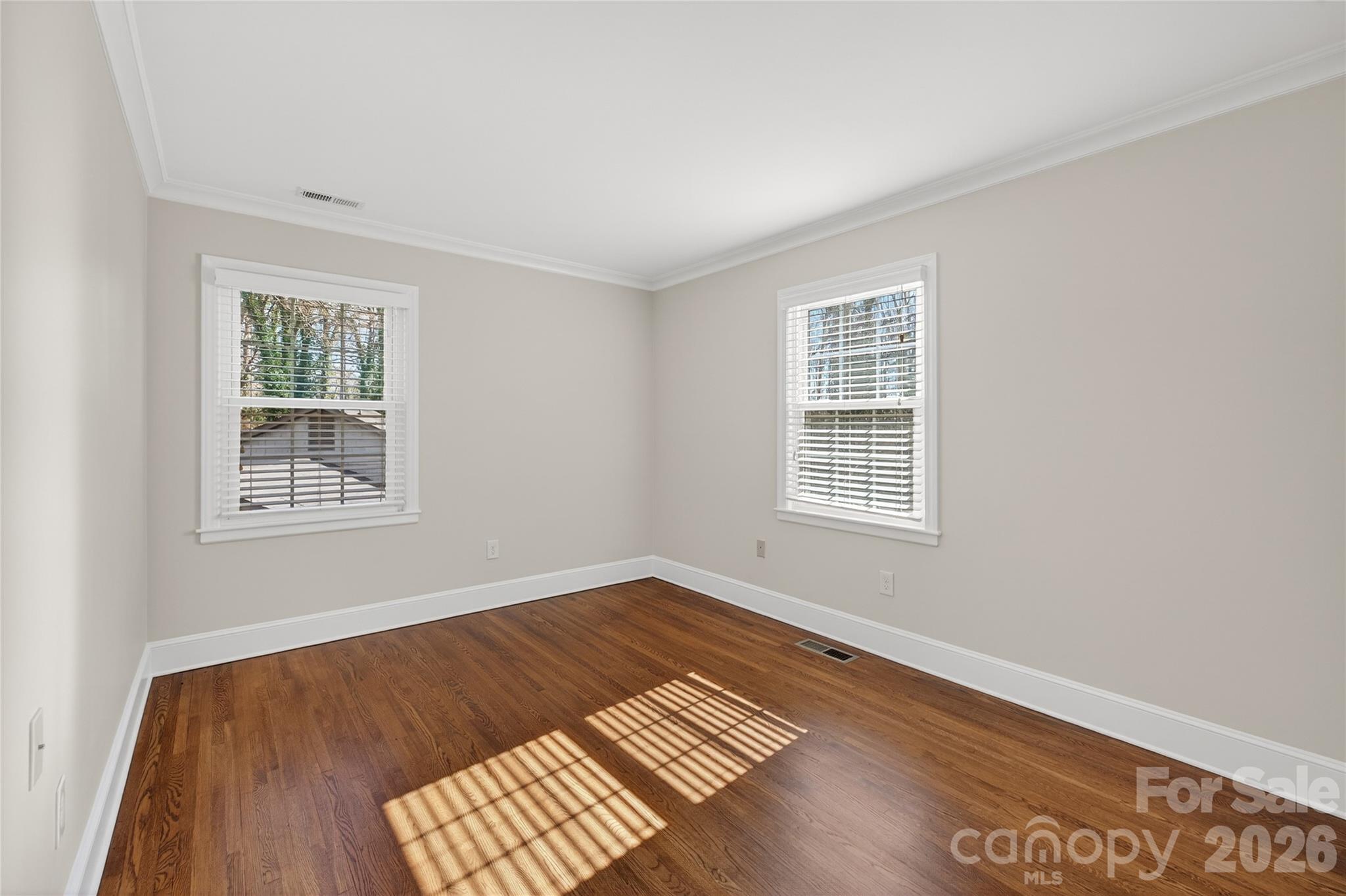 731 Sandridge Road Charlotte, NC 28210 - Photo 24 of 32 a view of an empty room with wooden floor and a window