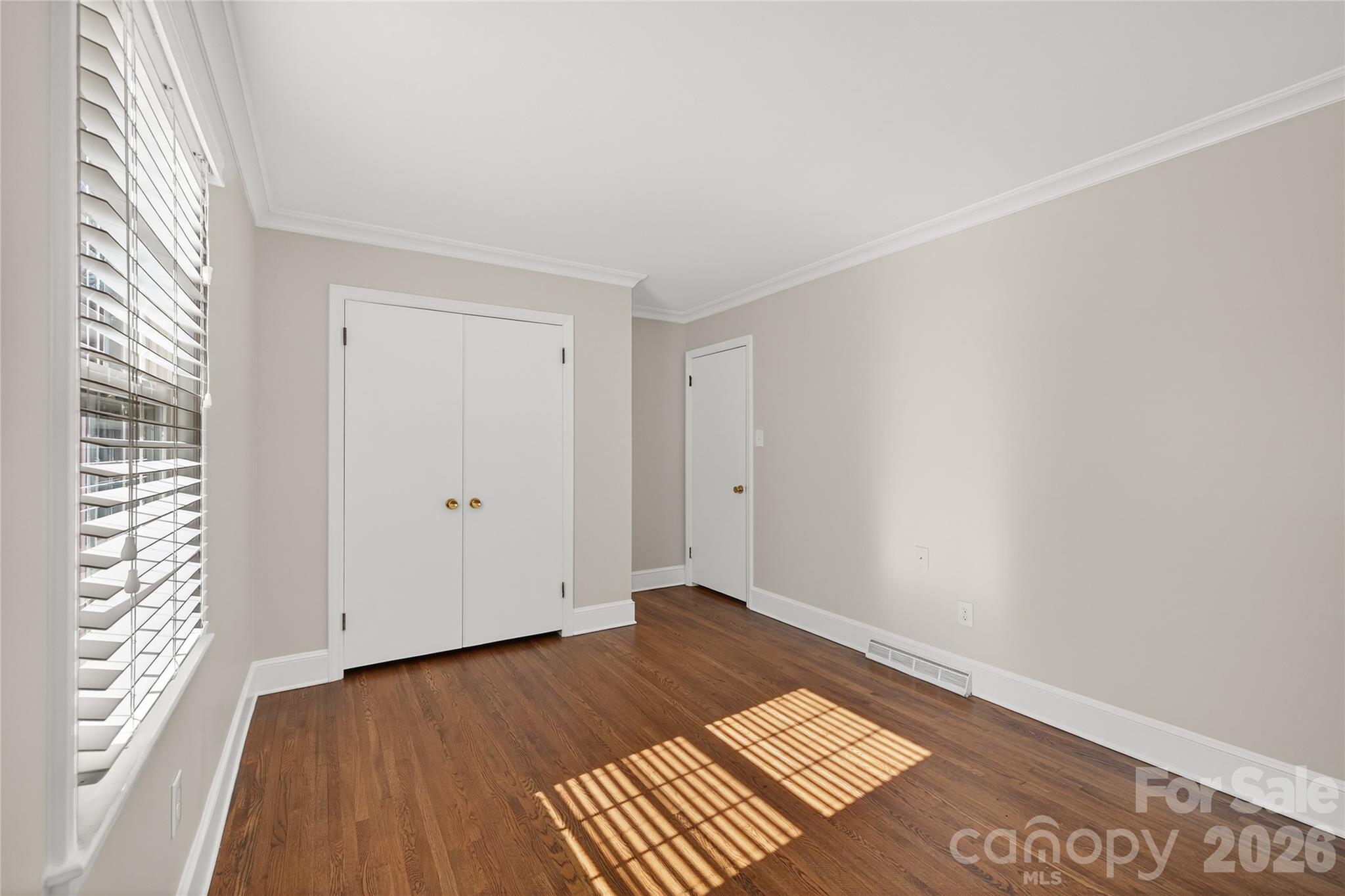 731 Sandridge Road Charlotte, NC 28210 - Photo 25 of 32 an empty room with wooden floor and windows