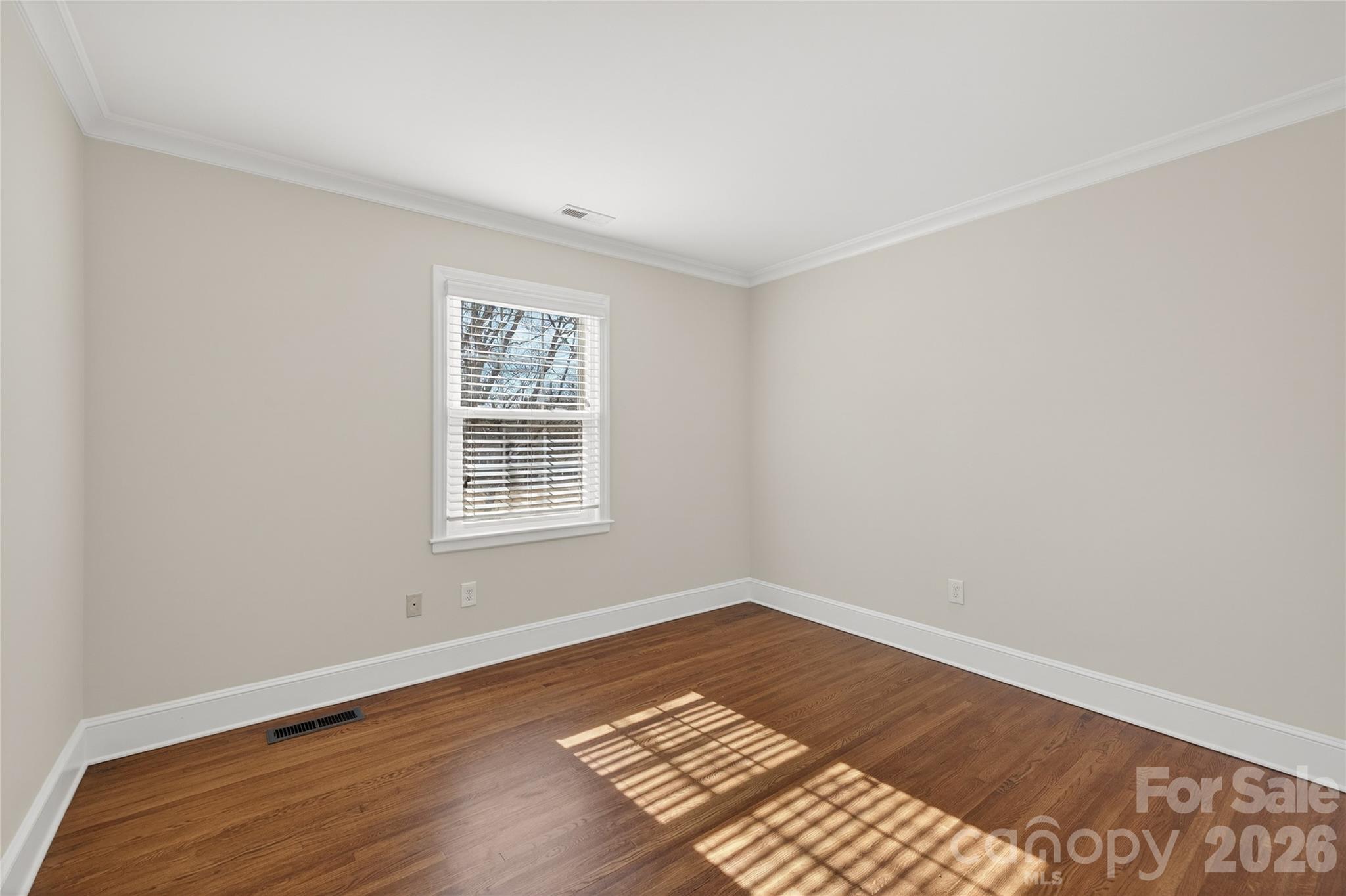 731 Sandridge Road Charlotte, NC 28210 - Photo 27 of 32 a view of an empty room with wooden floor and a window