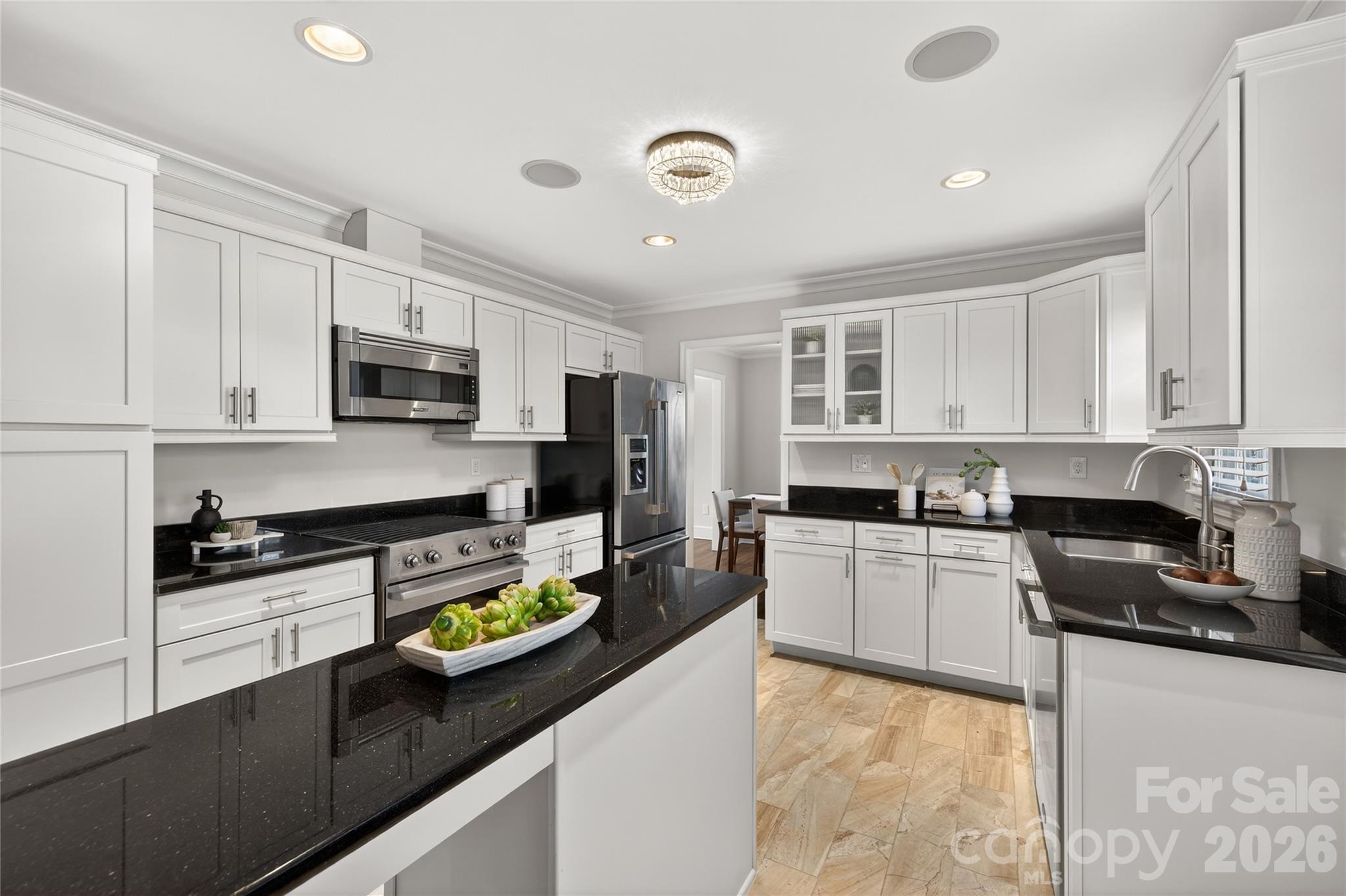 731 Sandridge Road Charlotte, NC 28210 - Photo 10 of 32 a kitchen with stainless steel appliances granite countertop a stove top oven a sink a stove a dining table and chairs