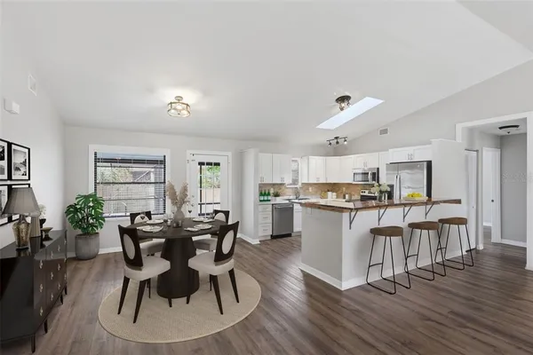 a view of a dining room with furniture and wooden floor
