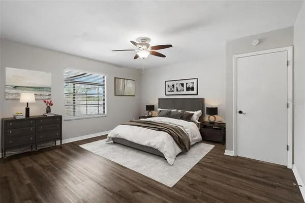 a spacious bedroom with a bed and a window