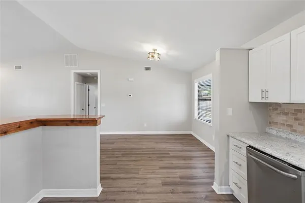 a kitchen with granite countertop a stove and a sink