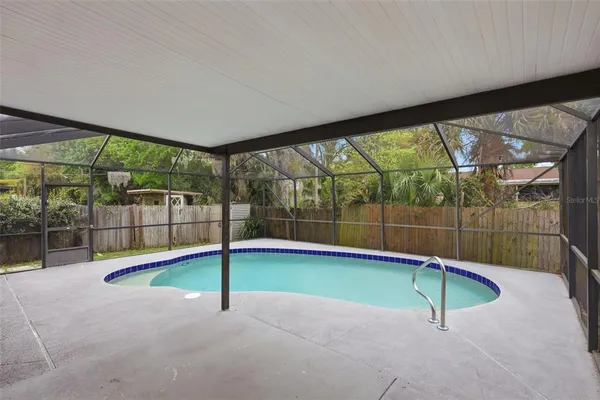 a swimming pool with a outdoor seating and yard
