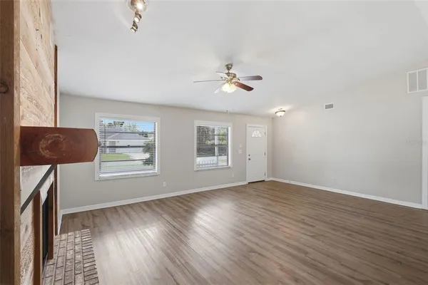 wooden floor in an empty room with a window