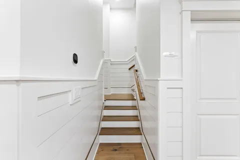a large white kitchen with a large window