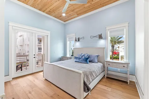 a bedroom with a large bed and a night stand