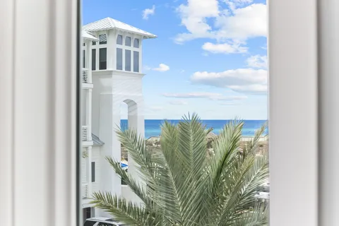 a view of a balcony with wooden floor and outdoor seating