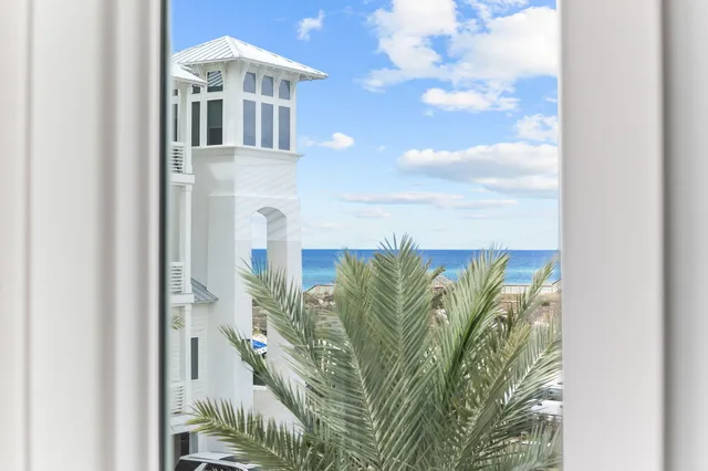a view of a balcony with wooden floor and outdoor seating