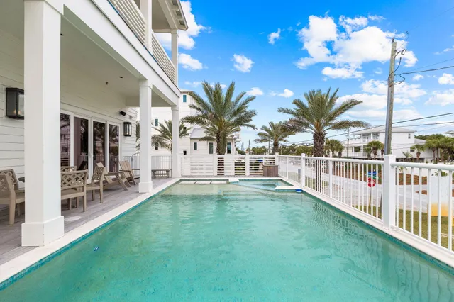 a view of a house with a yard and sitting area