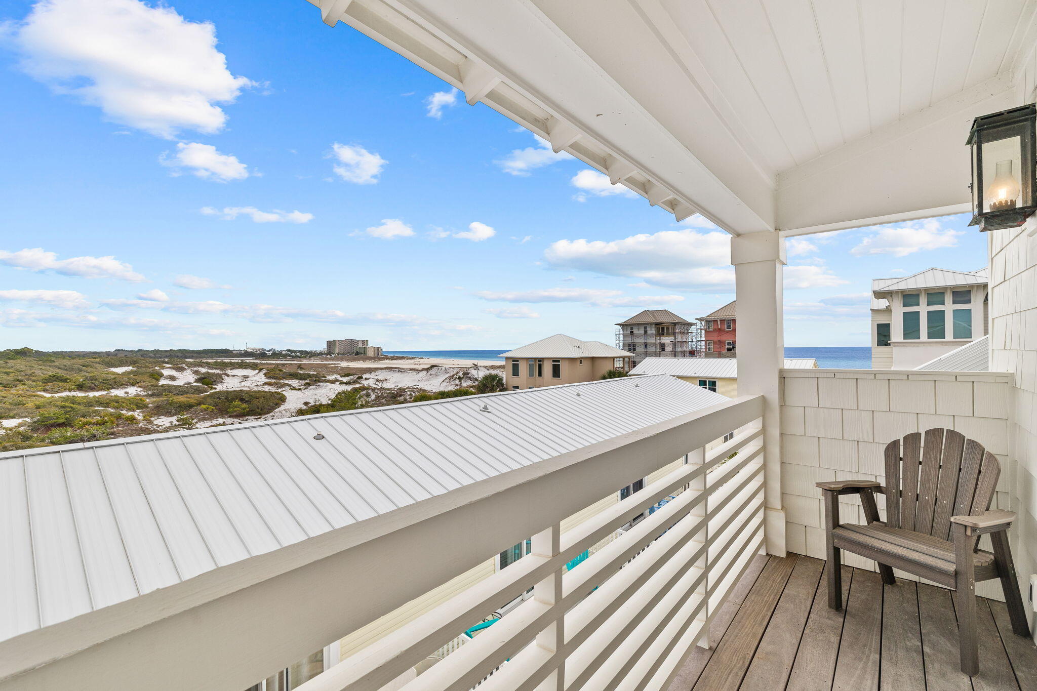 6 Palm Ct Lane Inlet Beach, FL 32461 - Photo 54 of 65 a view of a balcony with wooden floor and outdoor seating