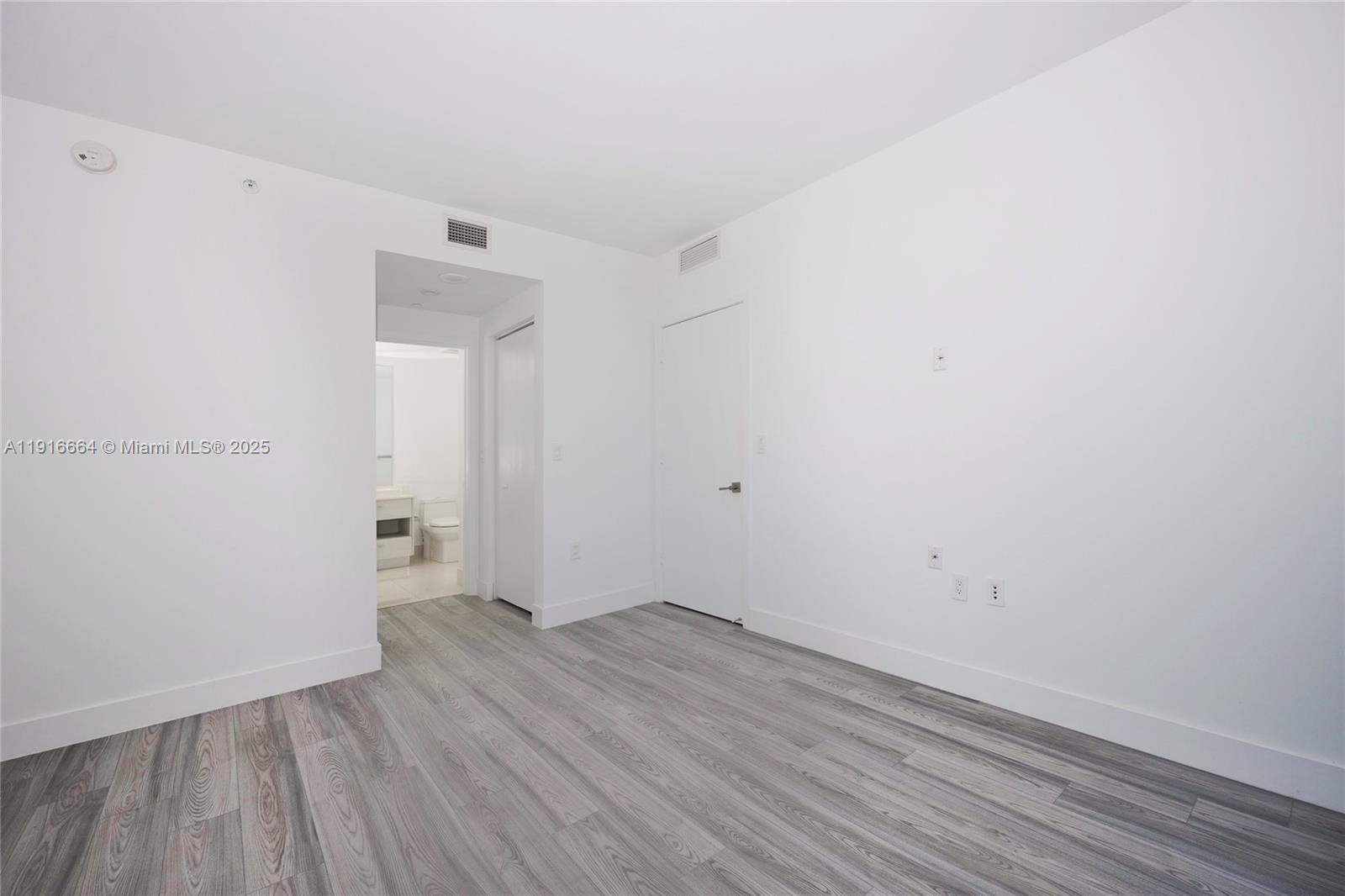 45 Southwest 9th Street, Unit 1504 Miami, FL 33130 - Photo 16 of 33 an empty room with wooden floor