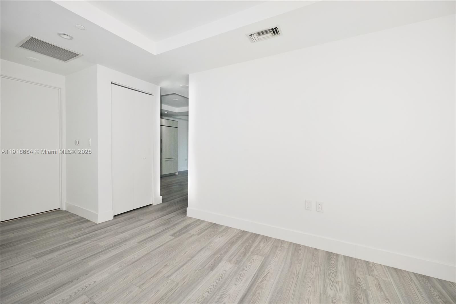 45 Southwest 9th Street, Unit 1504 Miami, FL 33130 - Photo 17 of 33 a view of an empty room with wooden floor
