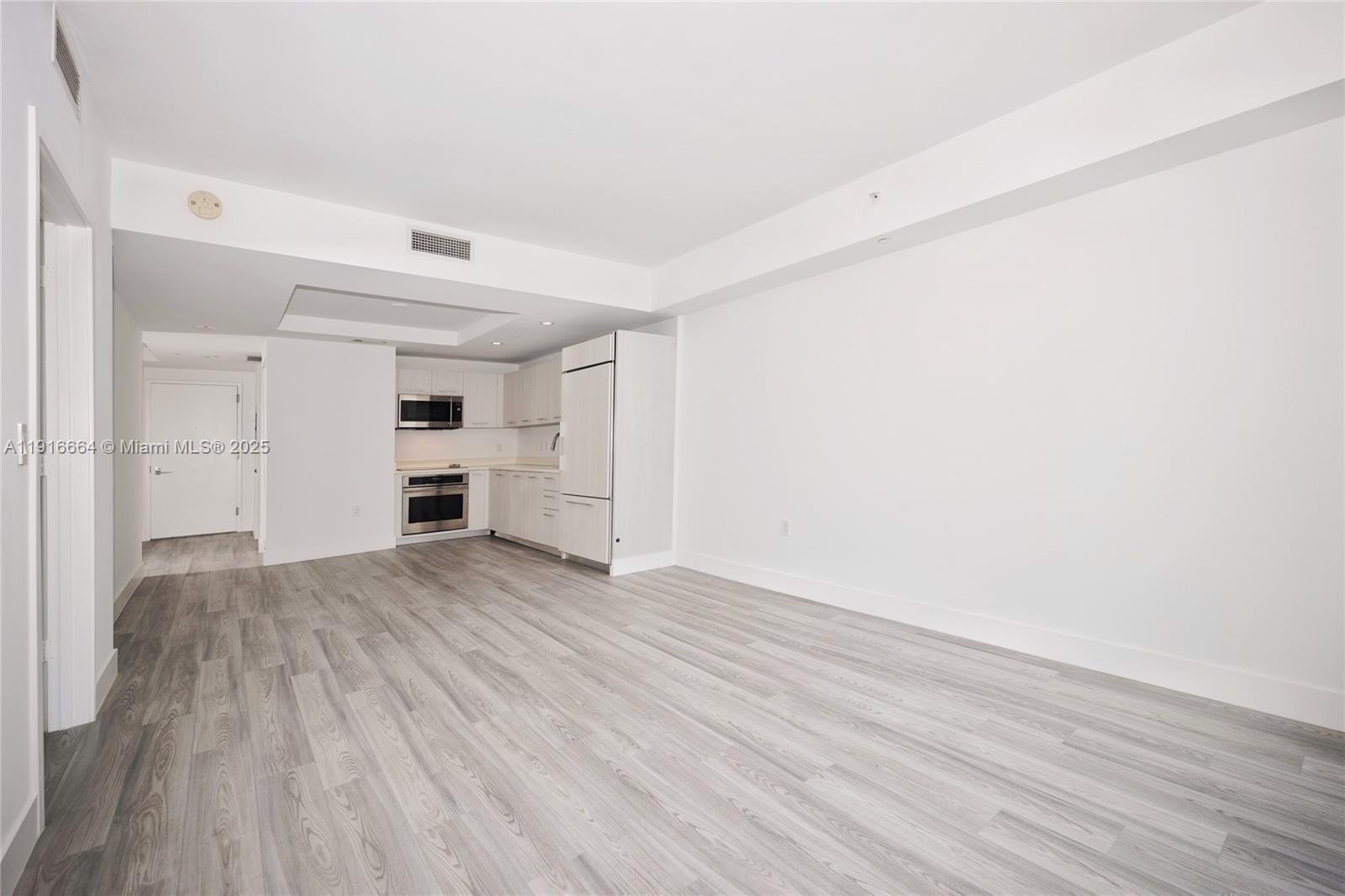 45 Southwest 9th Street, Unit 1504 Miami, FL 33130 - Photo 2 of 33 a view of empty room with wooden floor