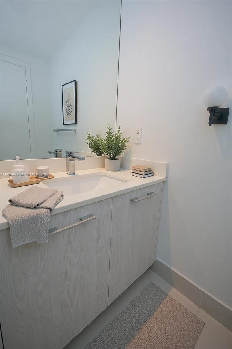 45 Southwest 9th Street, Unit 1504 Miami, FL 33130 - Photo 28 of 33 a room with a sink cabinets and wooden floor