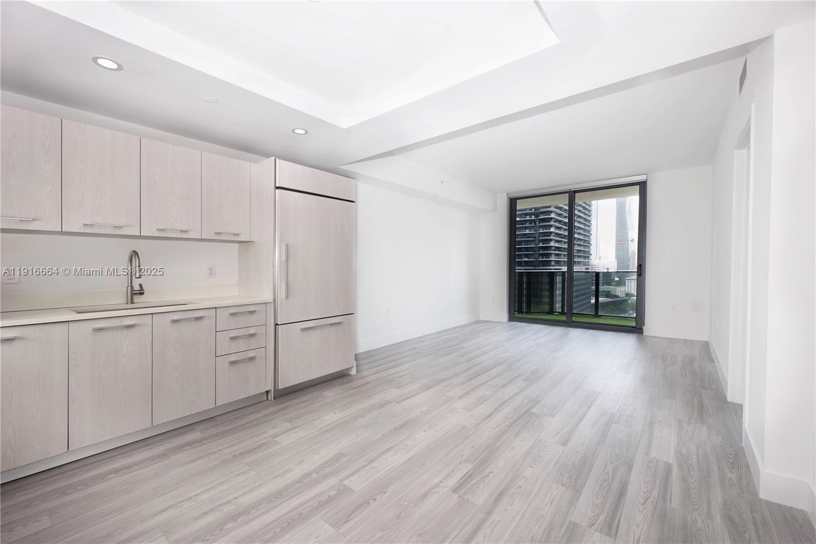 45 Southwest 9th Street, Unit 1504 Miami, FL 33130 - Photo 7 of 33 a kitchen with stainless steel appliances a refrigerator sink and cabinets
