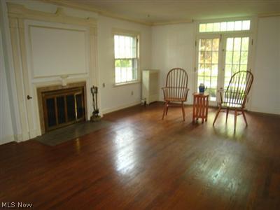 3317 Ingleside Road Shaker Heights, OH 44122 - Photo 3 of 19 Open and light filled living room with wood floors, fireplace and some floor to ceiling windows.