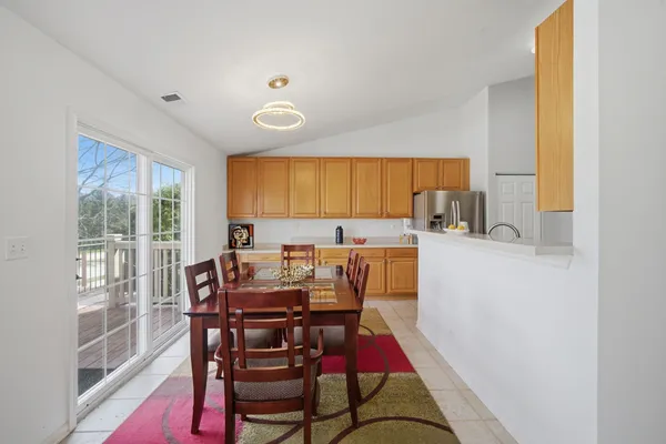 a view of a dining room with furniture and a window