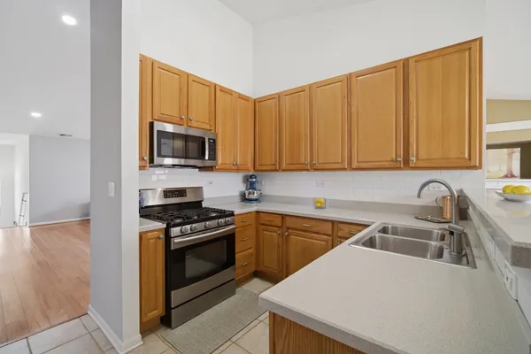 a kitchen with a sink a stove and cabinets