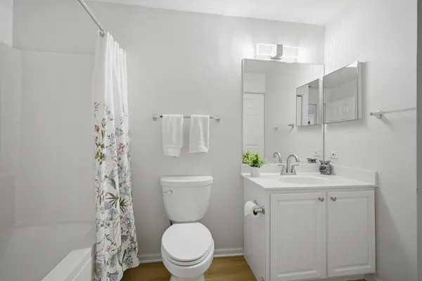 a white toilet sitting next to a bathroom sink