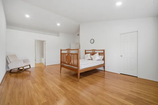 a view of a room with wooden floor and chair