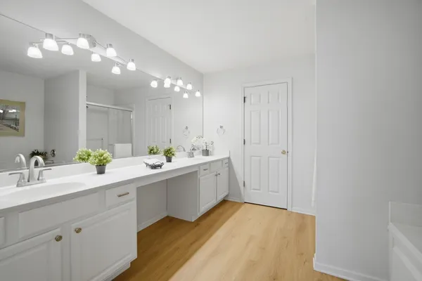 a bathroom with a granite countertop sink mirror and shower