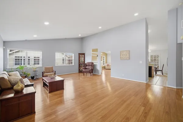 a living room with furniture and a wooden floor