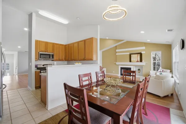 a dining room with furniture and a kitchen view