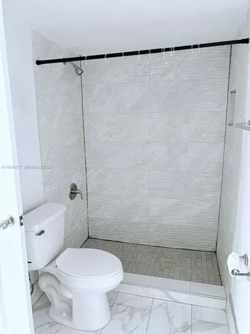 a bathroom with sink granite counter and mirror
