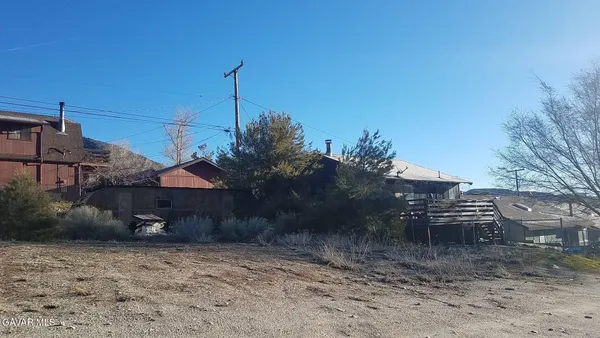 a view of a house with a yard and hanging chair