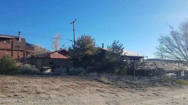 a view of a house with a yard and hanging chair