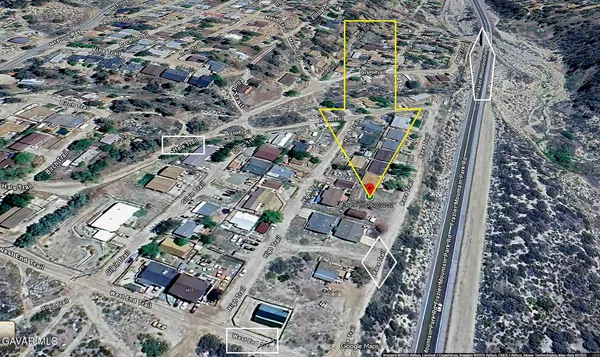 a view of a dry yard with mountain and mountain view
