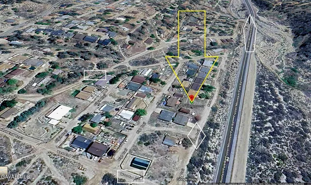 a view of a dry yard with mountain and mountain view