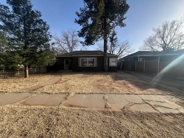 a view of a house with a yard covered with snow in front of house