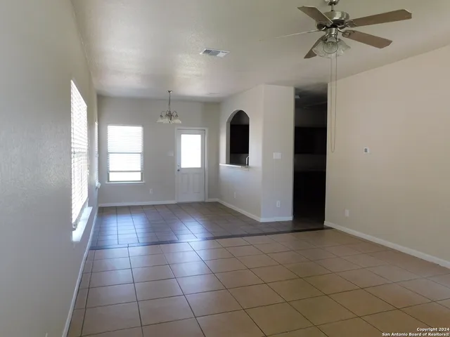 a view of a livingroom with a window and a ceiling fan